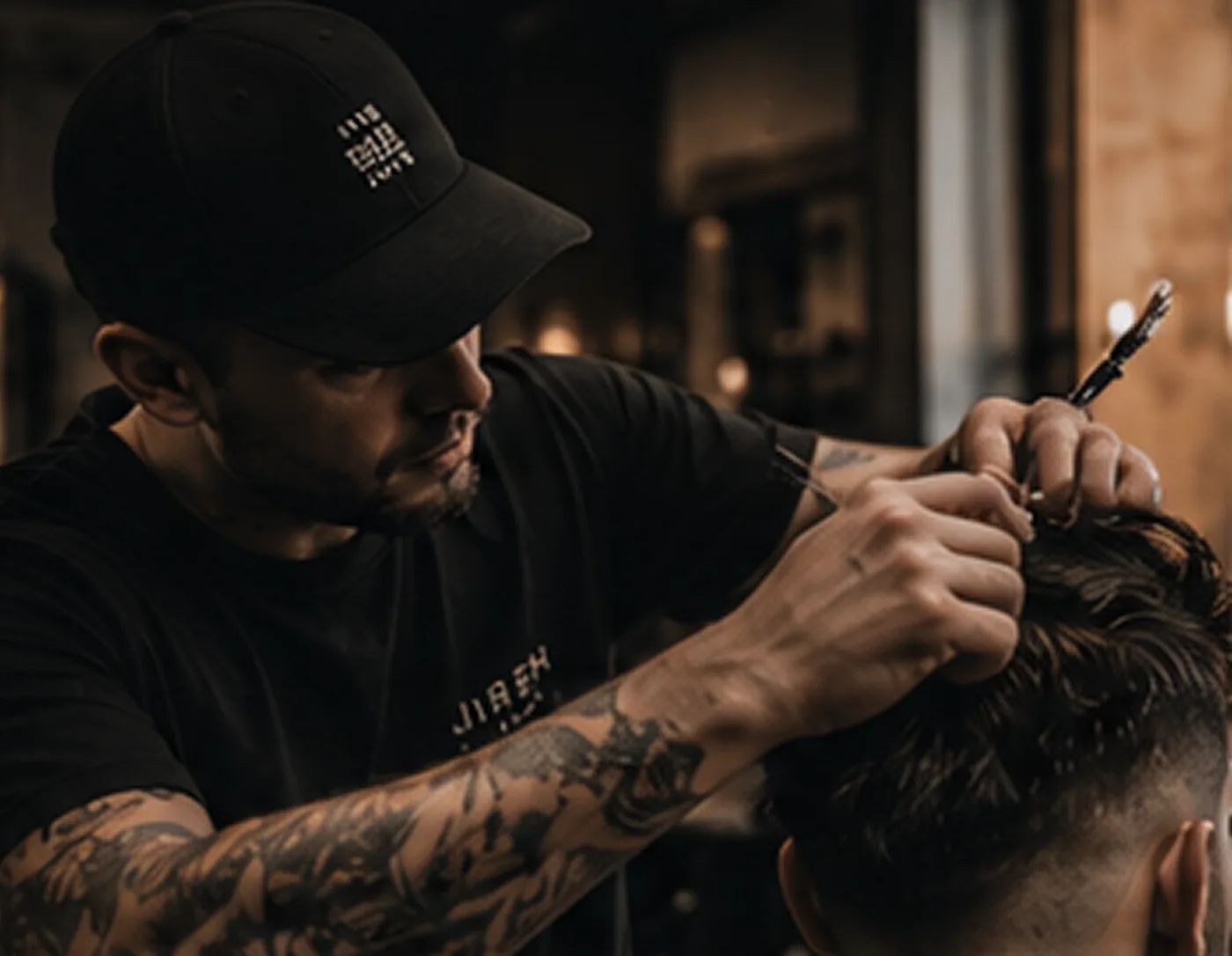 Barber in a cap working a client’s hair with scissors