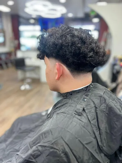 Curly cut with a low fade, side view
