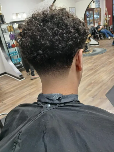 Textured curls with a fade at the nape